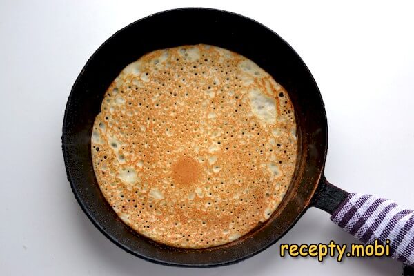 Yeast pancakes in milk with holes