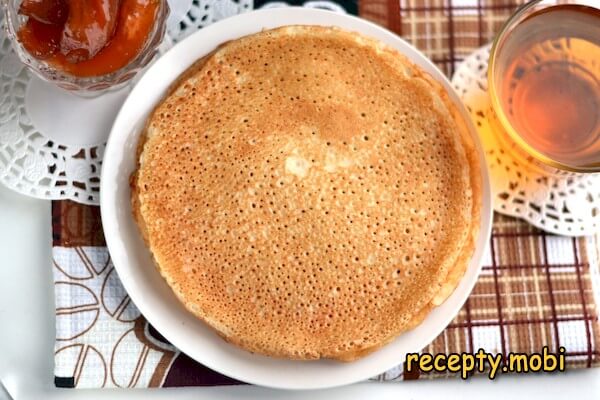 Yeast pancakes in milk with holes