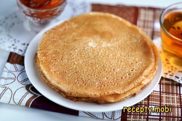 Yeast pancakes in milk with holes