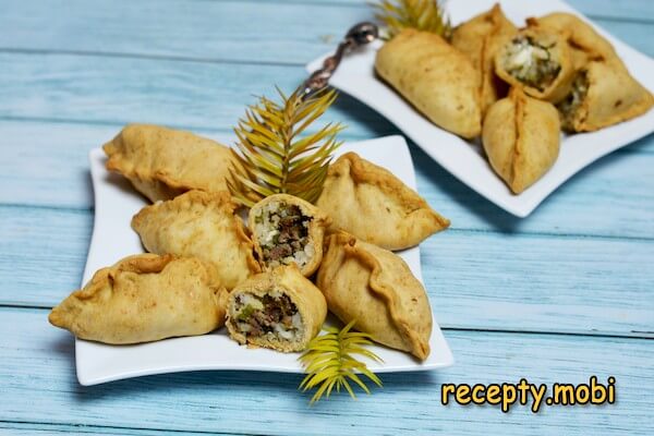 Pies with rice, chicken liver, eggs, green onions