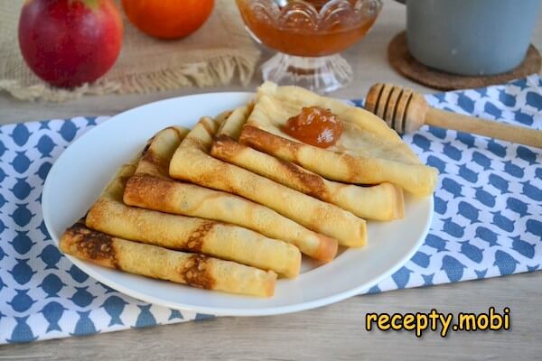 Thin pancakes on the water with eggs