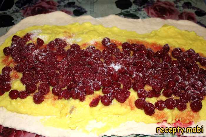 making a roll with cherries and custard