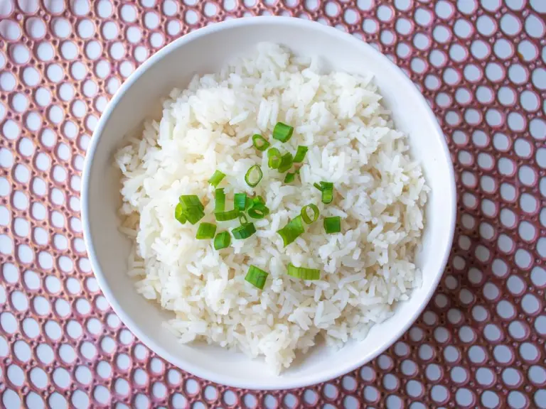 Fluffy white rice with green onions in a bowl