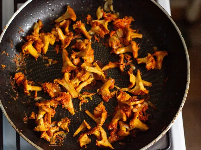 Mushrooms frying in a pan