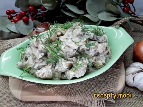 Eggplants in sour cream with garlic in a frying pan