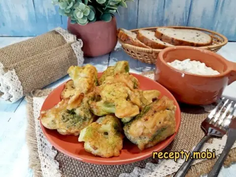Broccoli in batter in a frying pan