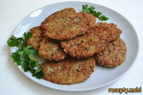 Potato pancakes with mushrooms in a skillet